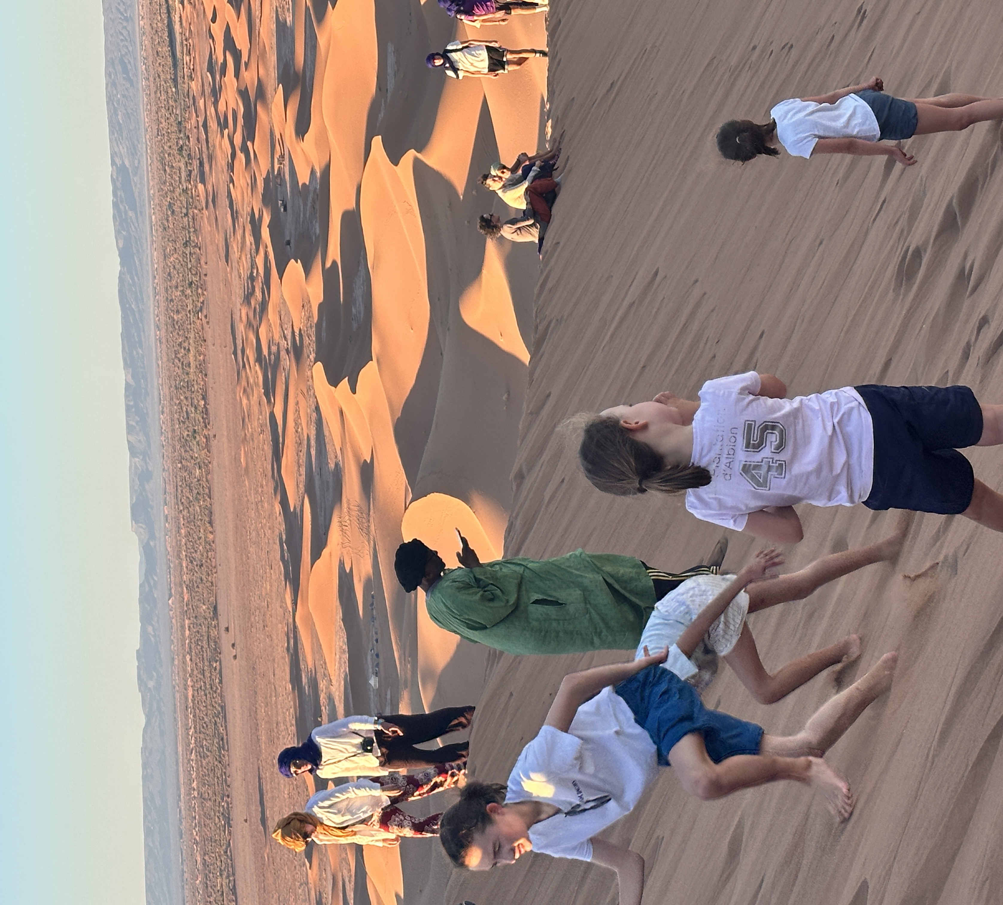 Kids play in the dunes south of Morocco